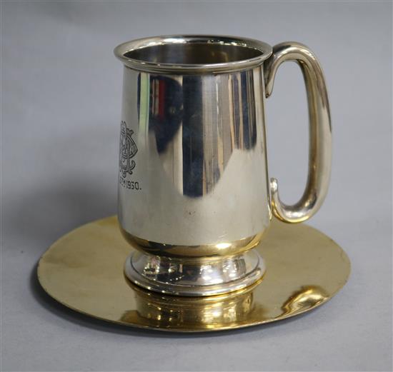 A George V silver christening mug and a silver gilt wafer dish.